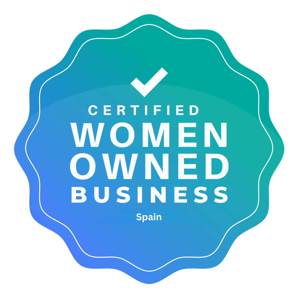 Logo of a Certified Women Owned Business in Spain, featuring a blue seal with wavy edges and a white checkmark at the top. The text inside the seal reads ‘CERTIFIED WOMEN OWNED BUSINESS’ with ‘Spain’ written underneath in gradients of blue-green